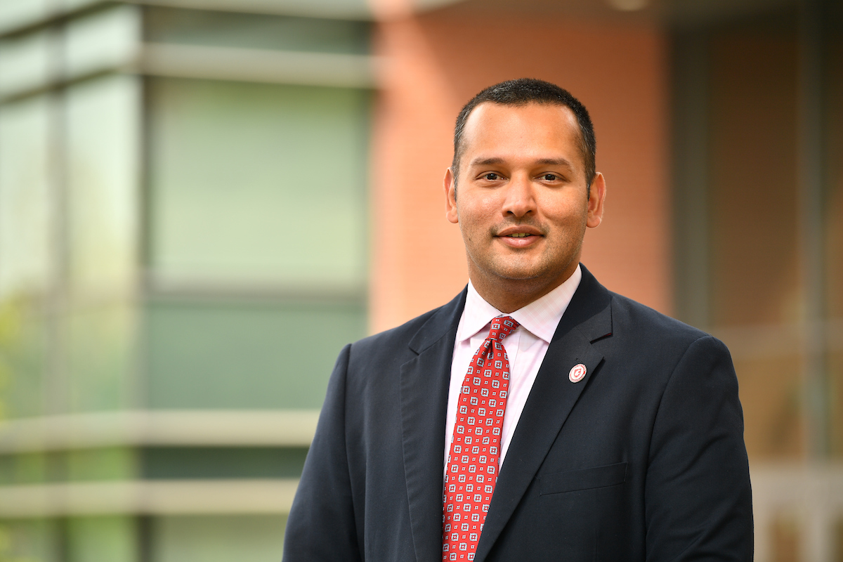 A photo of Daniel Saud in a suit with a red tie