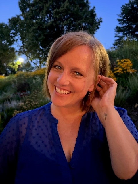 A smiling female in a blue top