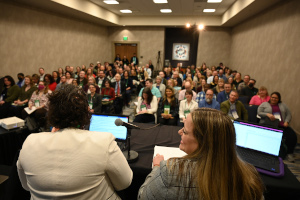 Two presenters in front of audience at the 2023 Annual Meeting