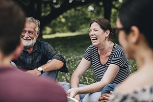 Group of people sitting in a park.