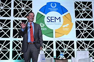Photo of Jeff Selingo speaking on stage at an AACRAO SEM conference.