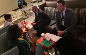 two sets of mentoring partners sitting and talking