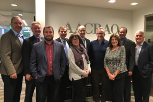 Group of 10 people poses for a picture near the new AACRAO building's elevator entrance