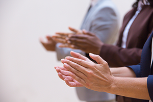 Group of people clapping hands.