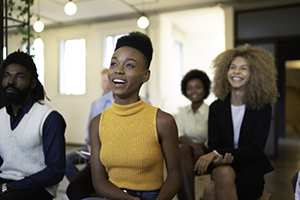 Group of professionals actively listening to a presentation.