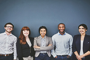 Group of young professionals smiling for the camera.