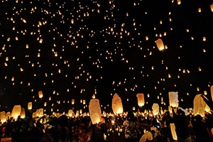 Group of people releasing sky lanterns.