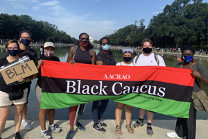 supporters of AACRAO's black caucus pose for a group photo in front of the reflecting pool in Washington DC