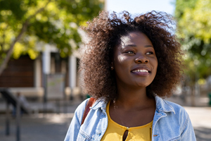 young black woman smiling on campus