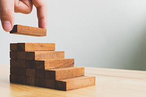 Stack of wooden blocks representing relationship building.