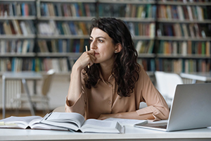 Young student working in a library.