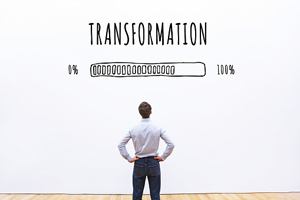 male looks up at a progressing bar that's about 75% full with the word "transformation" above the bar