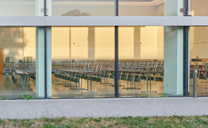 photo of large empty classroom with chairs upside down on rows of desks