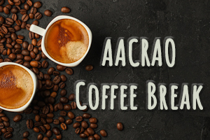 two mugs of coffee with coffee beans scattered on a black table with the overlaid text; "AACRAO Coffee Break"