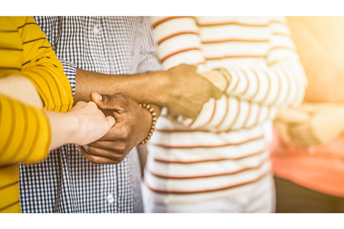 line of people holding hands