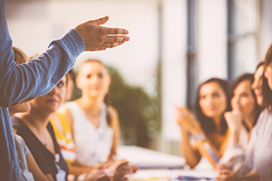 group of business people listening to a speaker