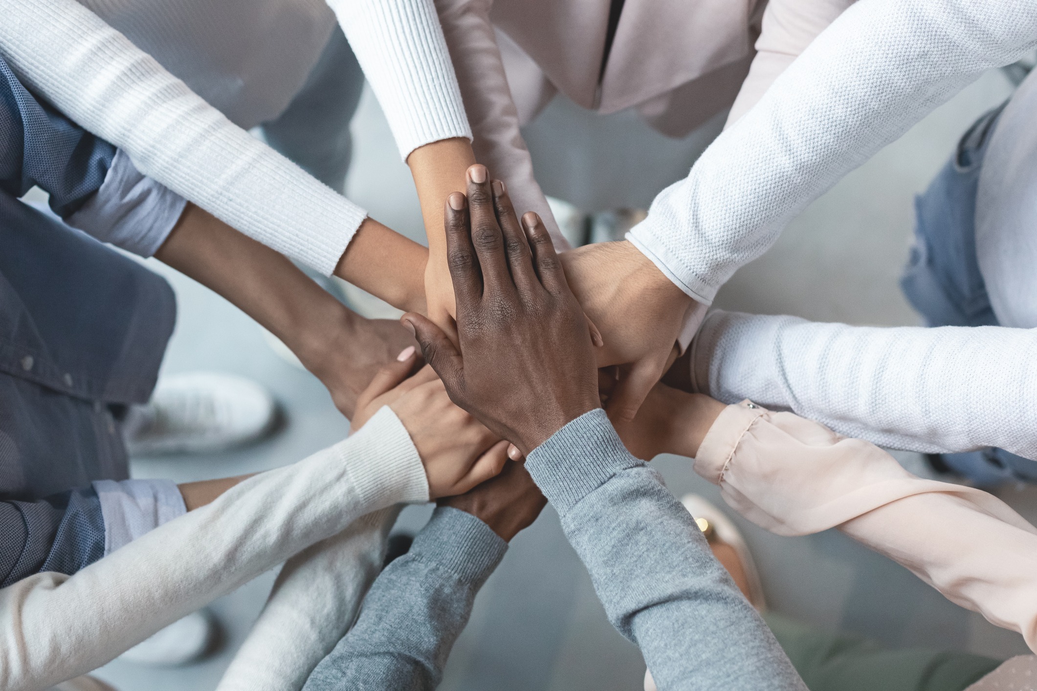 diverse group of hands stacked on top of each other