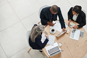 Group of professionals working at a round table.