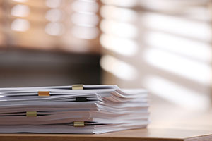 Pile of tabbed paperwork sitting on a desk.