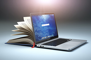 Image of a laptop and book.