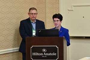 two people standing behind a podium