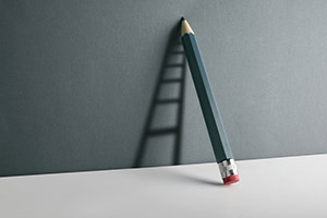 Illustration of a pencil leaning against a wall casting a shadow that appears as a ladder.