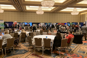 exhibit hall with circular tables filling the space