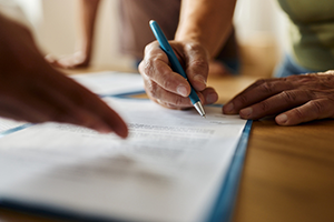 Individual filling out paperwork.