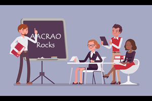 cartoon man presents to a group in front of a black board with the text "AACRAO Rocks" displayed