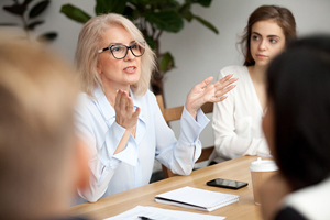 female speaks to a group out of frame