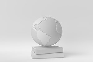 white-washed image of a globe sitting on top of 2 books