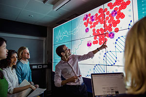 Group of medical students examining a graph.