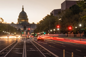 Photograph of street leading to Capitol Hill at dusk.