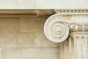 top of an ornate marble column 