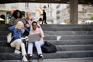 Group of students collaborating on a staircase.