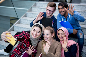 group of diverse students taking selfie