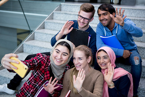 group of diverse students taking a selfie