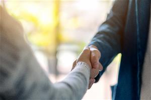 two people shake hands