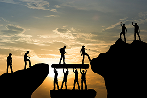 Group of hikers supporting each other in their goal to reach the summit.