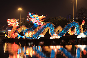 Photograph of two dragon lanterns on the water.