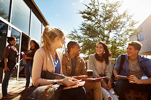 Group of university students sitting outside.