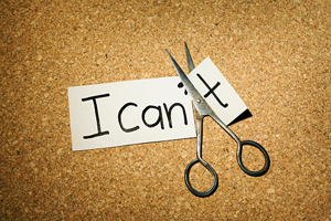 paper that says "I can't" with scissors cutting off the "t"