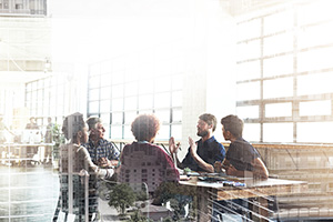 group of coworkers conversing while sitting at a table