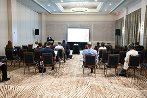 even space with audience members facing a screen at the front of the room