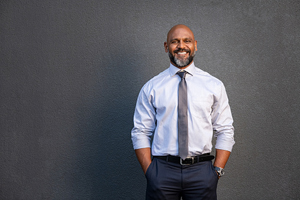 smiling businessman against dark background