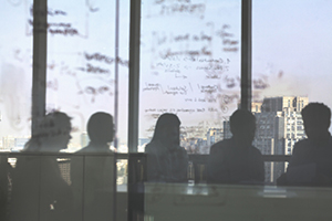 Photograph of a group of professionals setting at a table.