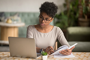 Individual studying on a laptop.