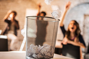 Photograph of students throwing away a test.