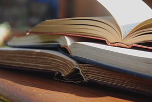 three open books stacked on top of each other