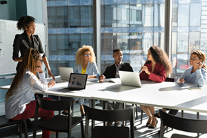 Group of professionals around a table conducting a meeting.